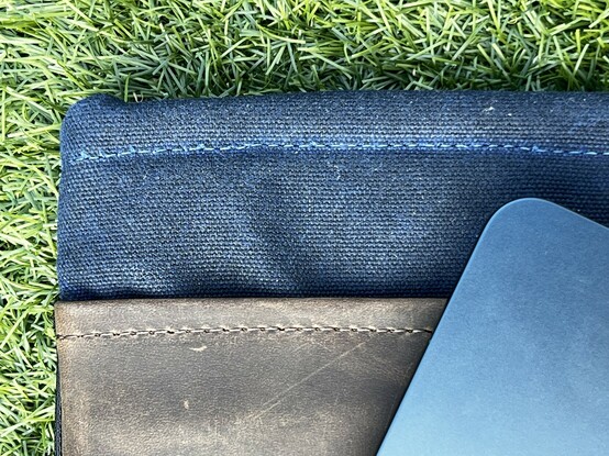 The corner of the MacBook Air peeking over the top of the folio.