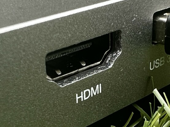 A close up of the HDMI port. It’s surrounded by the aluminium enclosure and the hole for the port- when looked at closely- resembles a very regular cave or the work of some stubborn cybernetic rats.
