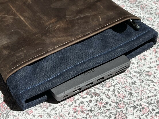 An Anker 7-in-1 dock sticking out of a sleeve case. The implication is that it’s plugged into a laptop.