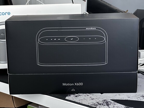 The outer sleeve lifts off the box to reveal a minimal grey inner design with a simple line art diagram of the X600. 