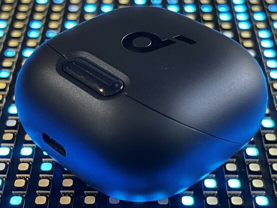 The soundcore Liberty 4 NC case- a small, rounded, blue object - sat atop an LED matrix showing random blue pixels.