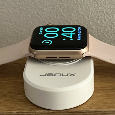 The Apple Watch with the JSAUX charger lying flat, like a normal Apple Watch charger.