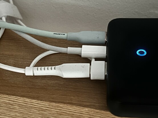 The JSAUX Apple Watch charger plugged into a desktop Anker power supply. The tether on the USB C adapter sticks awkwardly under the adjacent USB C plug. It wouldn’t fit well next to a USB A plug.