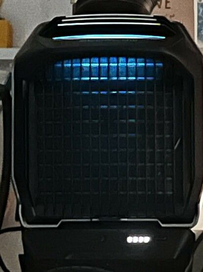 A photo of the front grille of the WAVE 2. It’s lit from above by an LED strip that runs in a little band across the top of the device, but shines down too. Honestly it makes it look more like a spaceship engine or a big flippin’ gun than an AC unit!

I’m … down with that.