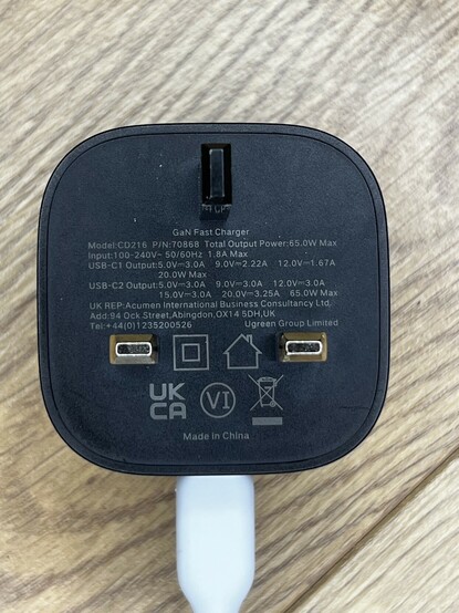 A photo of the UGREEN GaN Fast Charger showing the tiny text on the prong-side. It details all the caveats of the two ports but it’s a little small and hard to read.