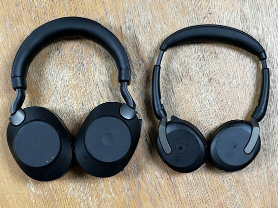 A picture of two sets of headphones. One over-ear set on the left with large ear cups and a thick, padded headband and some on-ear on the right with similar styling but much smaller, less padding and a subtle hint of folding hinges. Both fold, actually, but the smaller ones fold smaller.