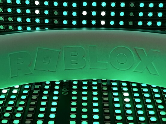 Inside of the headphones head and showing the white contrasting leatherette with the word ROBLOX embossed into it.