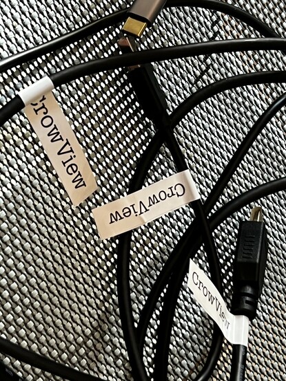 The same cables on a mesh chair showing off their not very neatly applied CrowView labels. It’s hard to wrap the sticky around and make a sticky sandwich- you have to get it right the first time.