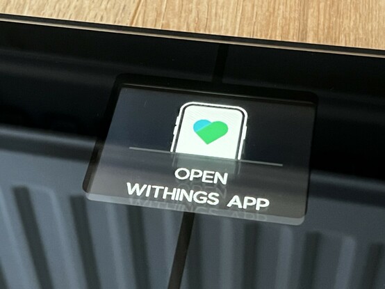 A closeup of the LCD showing the text “Open Withings App” alongside an icon of a phone.