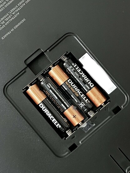 A photo of the battery compartment in the scales. Four AAA Duracell batteries are inserted.