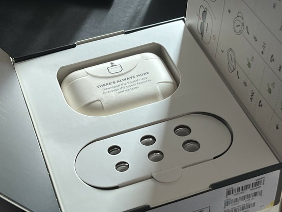 The inside of the Jabra Elite 10 box. The charging case and alternate ear tips (plus charging cable hidden beneath) are nestled within a rather large cardboard insert with empty space around it.