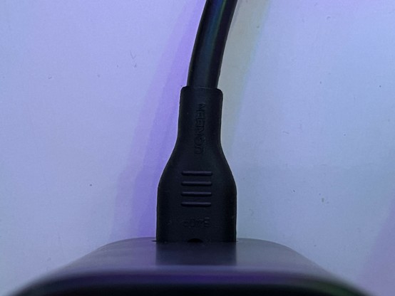 A C7 or “Figure Eight” cable disappearing into the back of UGREEN’s 2-in-1 desktop charger.