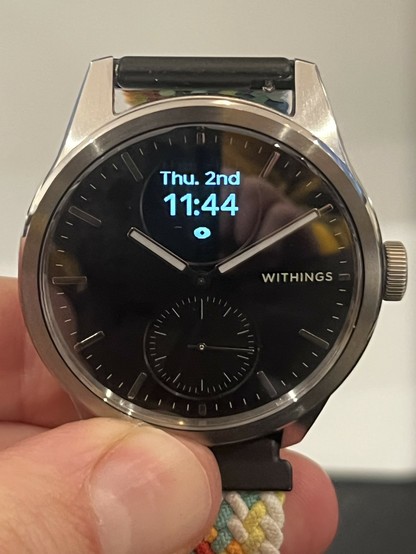 The ScanWatch 2 with the OLED display showing the date, time and a little eye icon. The font is surprisingly soft for a low resolution display.