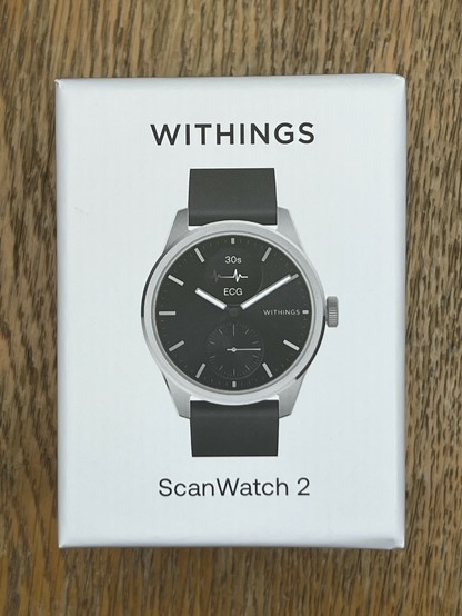 The small, cuboid, ScanWatch 2 box. It’s quite plain, white with a crisp picture of the watch and “Withings” at the top and “ScanWatch 2” on the bottom.