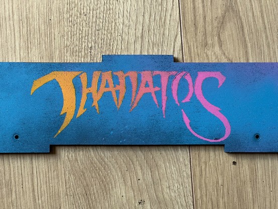 A blue painted wooden panel with the word 