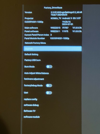 A screenshot of a factory settings menu for a KONKA TV projector, showing various technical details such as software versions, panel module number, and different configuration options like 