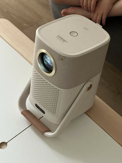 A portable Yaber projector with JBL speakers sits on a table.