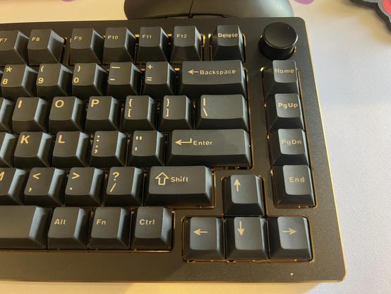 The right side of the Epomaker Tide75. A 75% keyboard in black and gold with grey keycaps and yellow-gold legends.