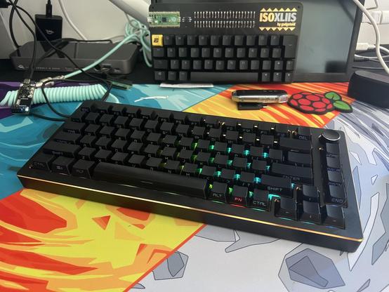 A black keyboard with a gold chamfer around the edge, backlight with green lights.