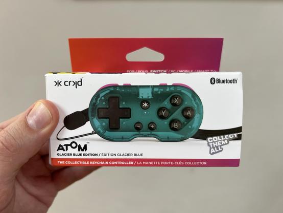 A box for a tiny collectible keychain game controller called 