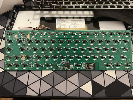 Overview shot of a mechanical keyboard PCB showing an STM32F072 MCU and an unidentified RF module.