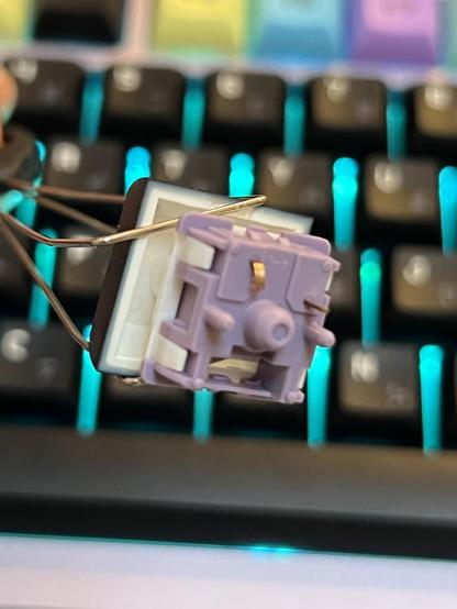 A single mechanical keyboard switch with a bent pin.