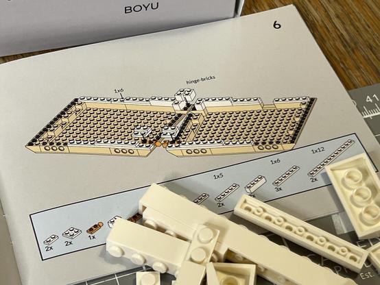 Assembly instructions for a building brick keyboard with bricks placed in the last step depicted in beige and bricks to be placed depicted in white. There’s a lot happening in this one image and you’re expected just to figure it all out.