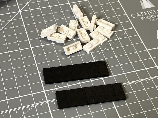 A pile of 1x2 LEGO style plates and a couple of strips of soft foam pads to fit over them.