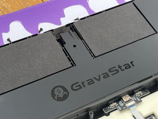 Inside the keyboard showing a GravaStar logo in the rubber damping material and two cut outs for LiPo batteries that have been filled with high density foam inserts.