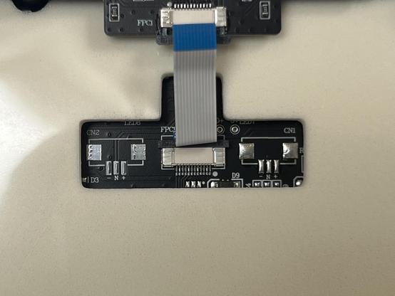 Closeup of a PCB showing two unpopulated JST LiPo battery connectors either side of the USB port FPC connector.