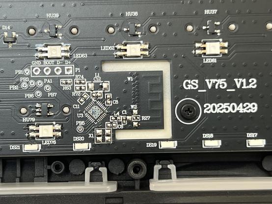 Closeup of a keyboard PCB showing a PCB Bluetooth antenna and some unpopulated supporting components.