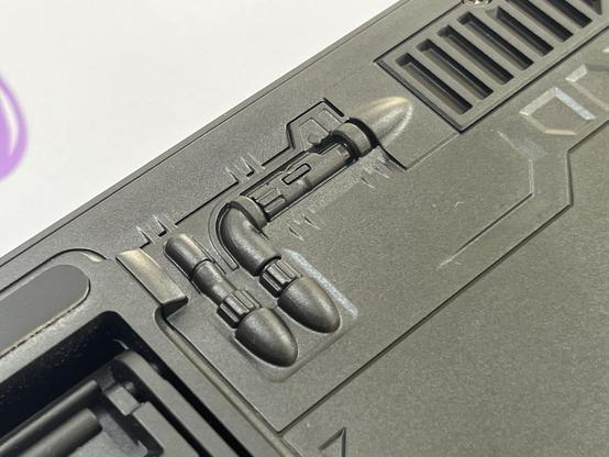 The plastic underside of a keyboard showing design elements that can only be referred to as “spaceshippy.”
