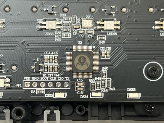 A mechanical keyboard PCB close up showing an MCU with a Gravastar logo etched onto it.