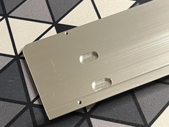 A hunk of aluminium… the keyboard badge. Some rough tooling marks on the inside but nothing exciting.