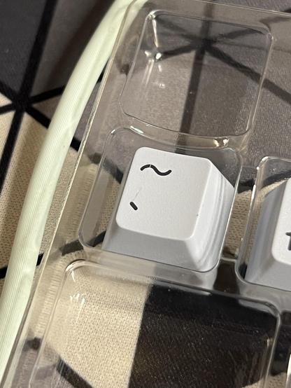 A tilde/backtick key the wrong size/profile to fit left of Z.