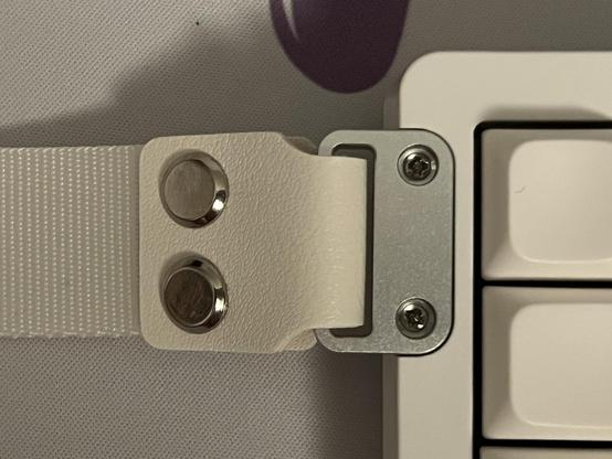 The strap assembled and screwed onto the keyboard.