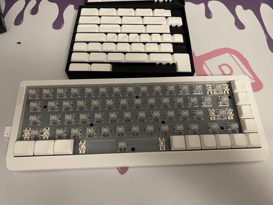A partially populated keyboard in front of a box of completely white keycaps.

Concave, convex, who’s counting?