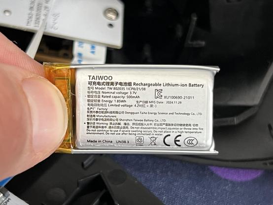 Closeup of a TAIWOO branded LiPo battery, claiming 500mAh and a nominal 3.7v. It looks a little puffy, though I’m not sure it actually is. The battery is not much wider than the thumb and finger grasping it.