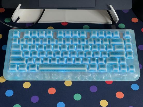 The keyboard with the aluminium trim bar installed, looking noticeably out of place amidst a sea of glowing translucent blue.