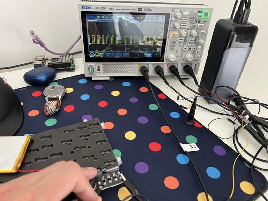 An oscilloscope showing - to the trained eye - an unmistakably WS2812 addressable LED signal coming from the unpopulated LED placements on a mechanical keyboard.