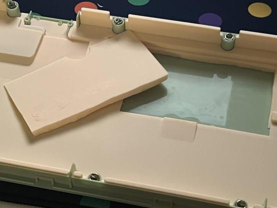 A chunk of the silicone damping cut out to accommodate the LiPo battery and leave the PCB more wiggle room.