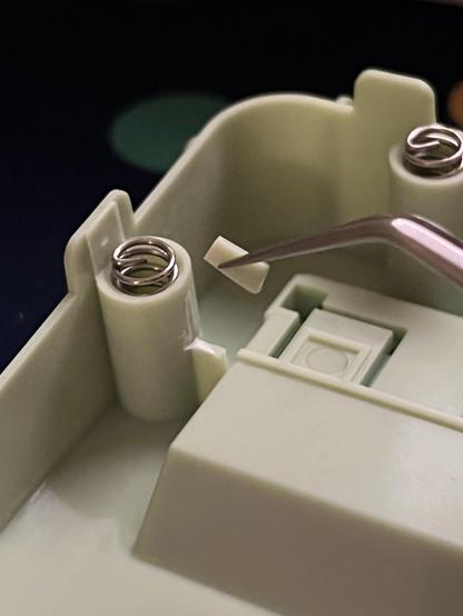 A small notch of plastic cut away from the spring gasket mount mechanism, preventing the PCB from bottoming out so quickly.