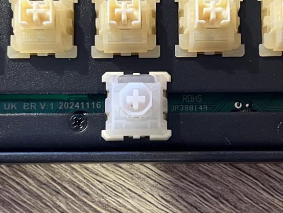 A clear and white Wuque Studio Flux magnetic switch installed into the spacebar socket.