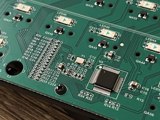 The back of a Hall-Effect keyboard PCB showing a cluster of resistors and capacitors next to a microcontroller.