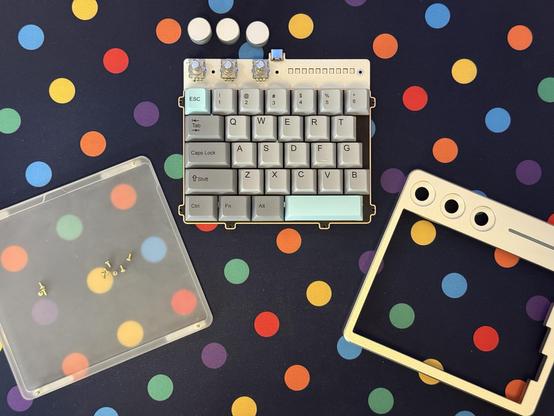 The acrylic bottom, PCB/plate assembly and aluminium top of the Cybrix29 half-a-keyboard laid out side by side.