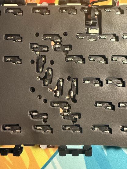 A busy cluster of hotswap mechanical keyboard sockets on the reverse of a PCB.