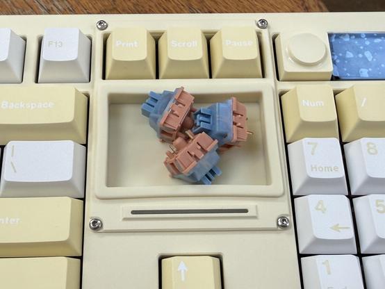 The home/end etc keys replaced with a litre silicone storage tray. Three switches are sat in the tray showing its relatively small size.