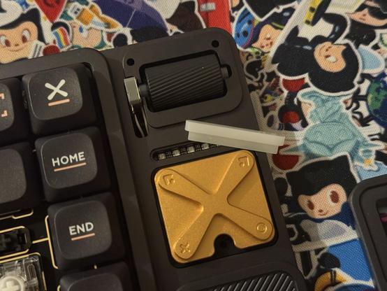 The faceplate over the media buttons and volume roller has been removed, the light pipe for the LED bar has been set aside and multiple LEDs are peeking out. The rotary encoder for the roller is just loosely mounted into a slot with wires soldered directly to it, routing to a JST connector beneath the board and ought of sight.