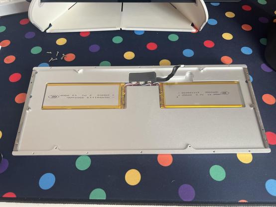 The bottom half of a mechanical keyboard PCB with two fairly generic looking 3500mAh batteries recessed into it.
