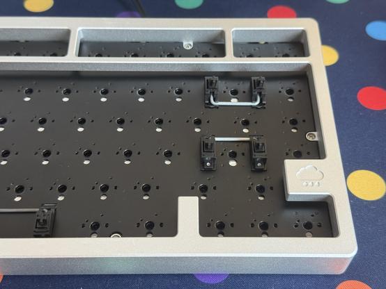 Black plastic keyboard switch stabilisers screwed into a black mechanical keyboard PCB for a much cleaner look.